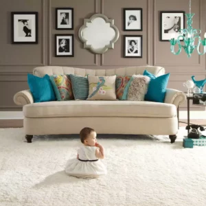 Cute baby sitting on comfortable carpet | House of Carpets and Lighting